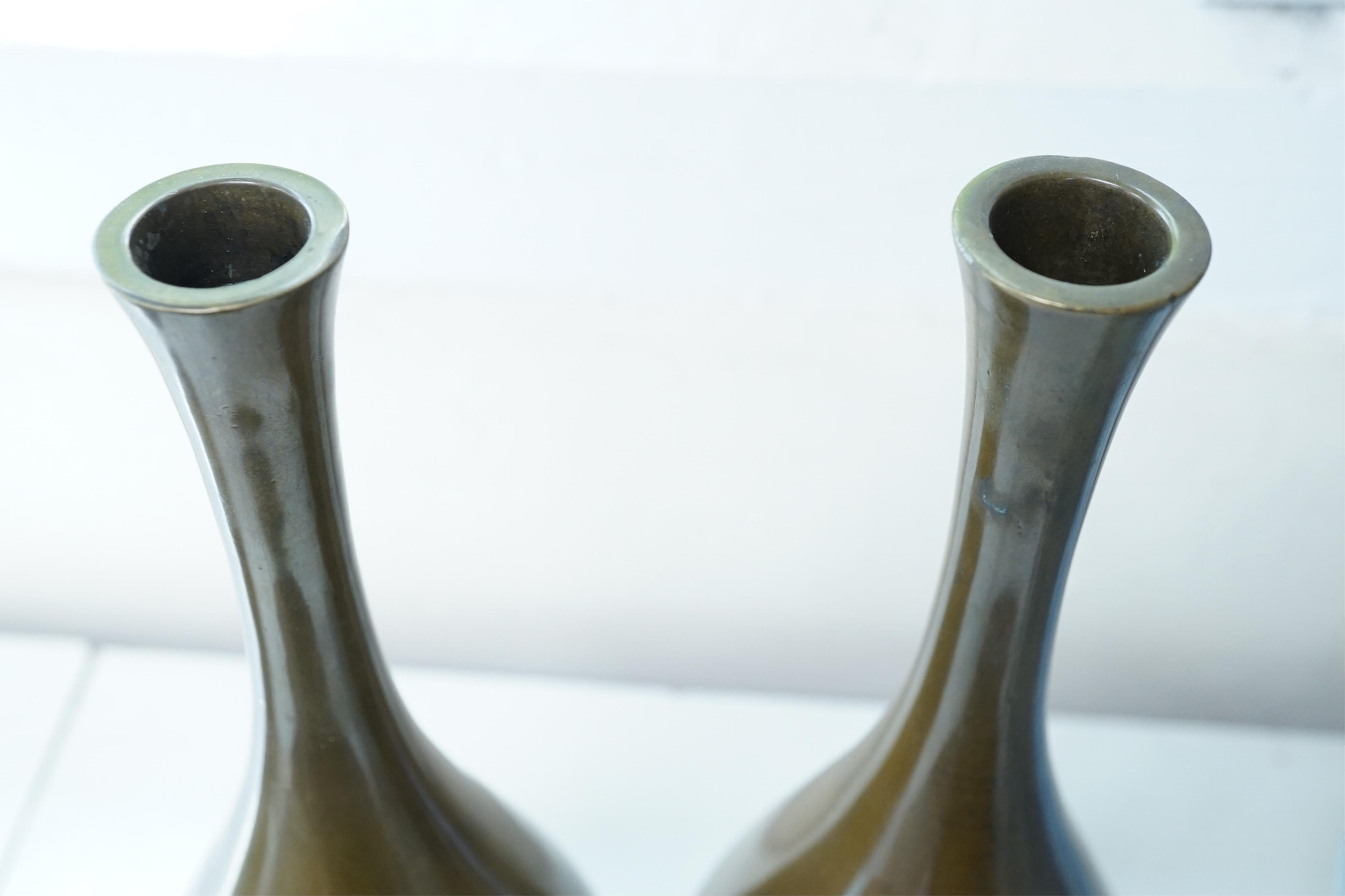 A pair of Japanese bronze and mixed metal inlaid bottle vases, signed Hidemitsu, Meiji period